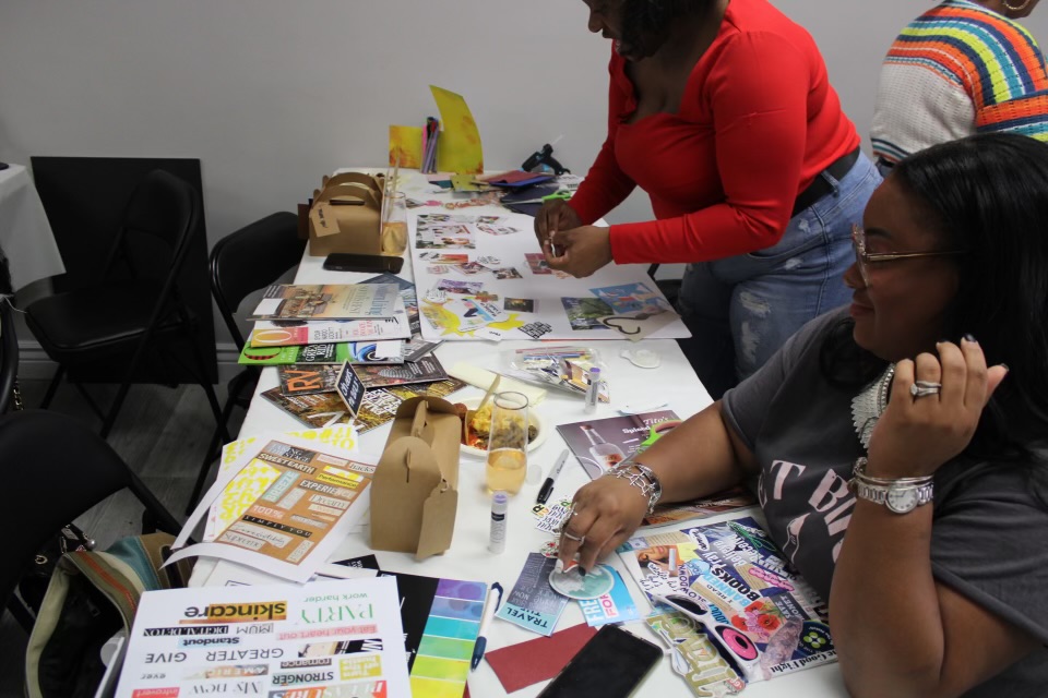 Guests working on collages and vision boards at a creative workshop